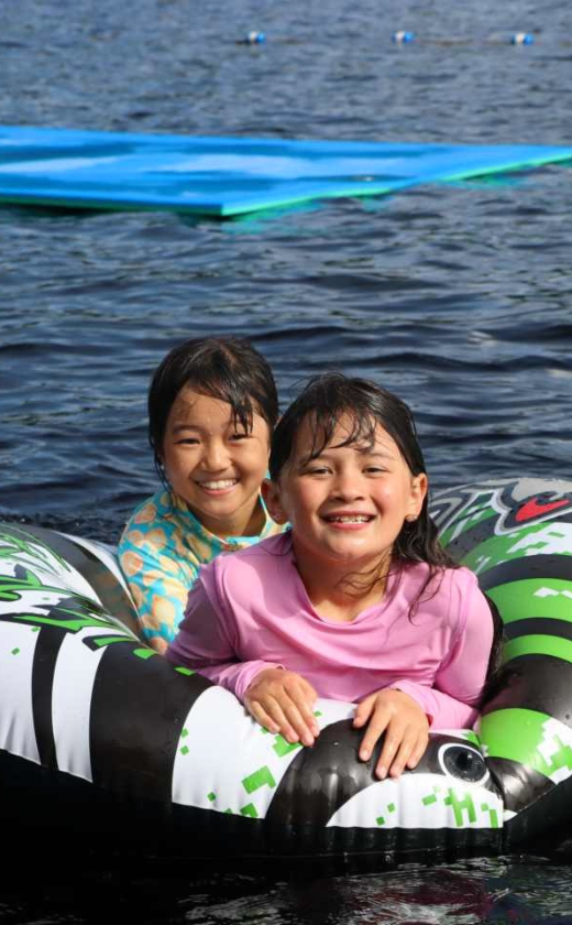 Campers at the waterfront at summer camp. Playing in the lake at sleepaway camp in New Hampshire.