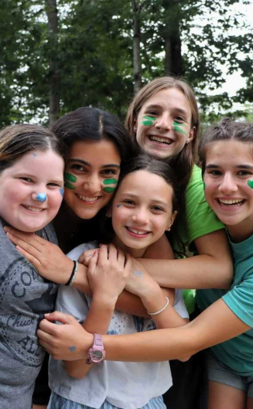 Campers playing capture the flag at summer camp. Sleepaway camp in New Hampshire.